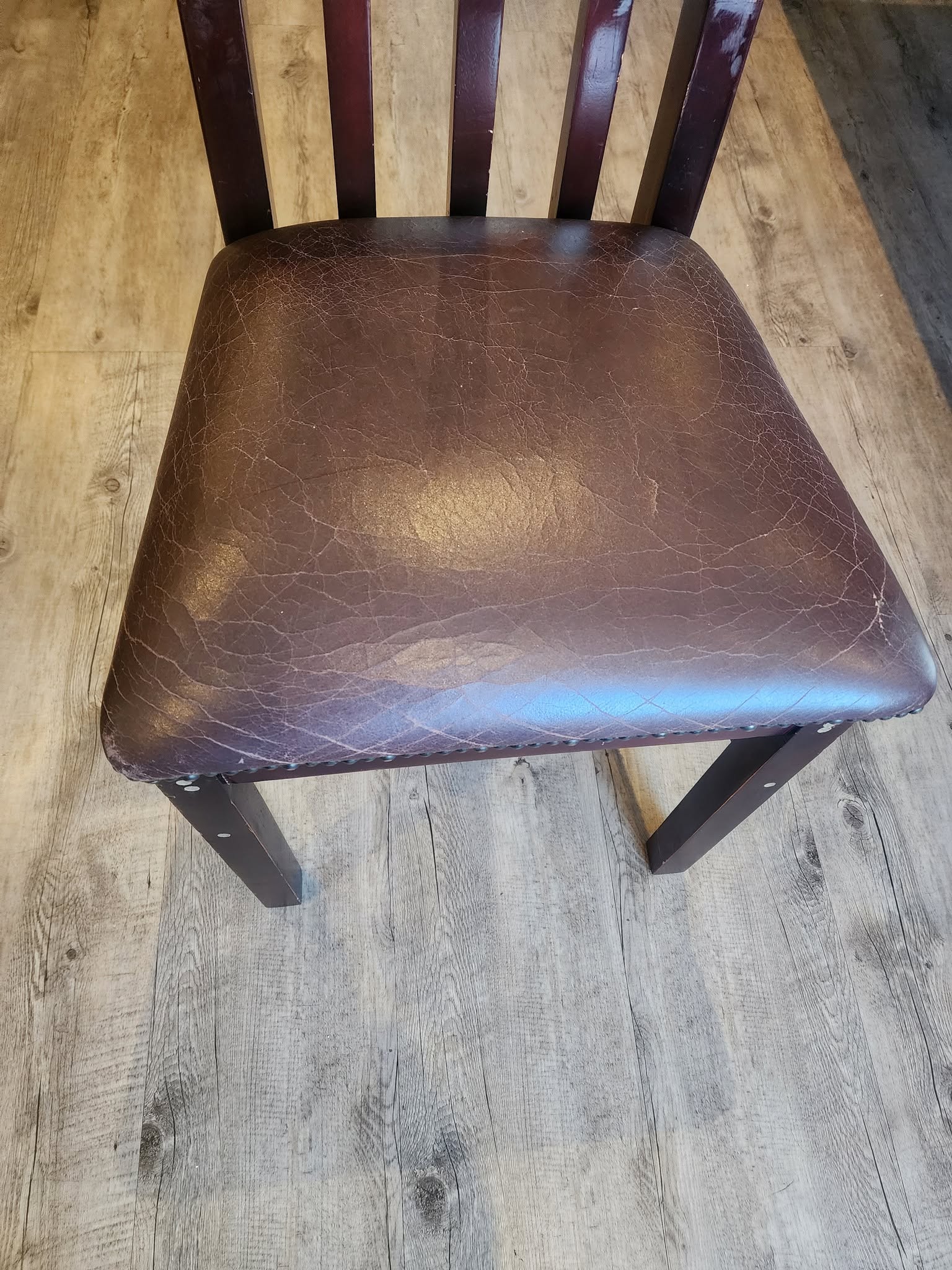 Leather dining chair before upholstery cleaning Brackenfell